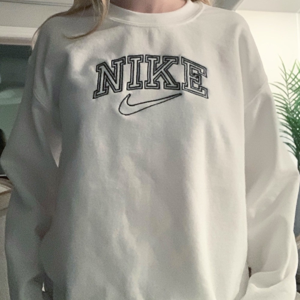 White crewneck with black "Nike" design